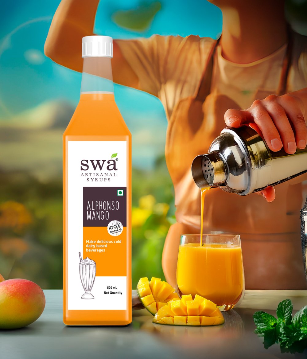 Swa Alphonso Mango syrup poured into a shaker, with fresh mangoes